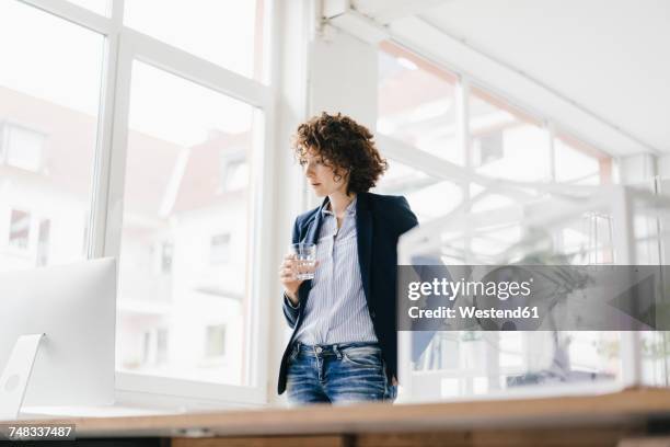 businesswoman in office looking at computer - bonsai tree office stock pictures, royalty-free photos & images