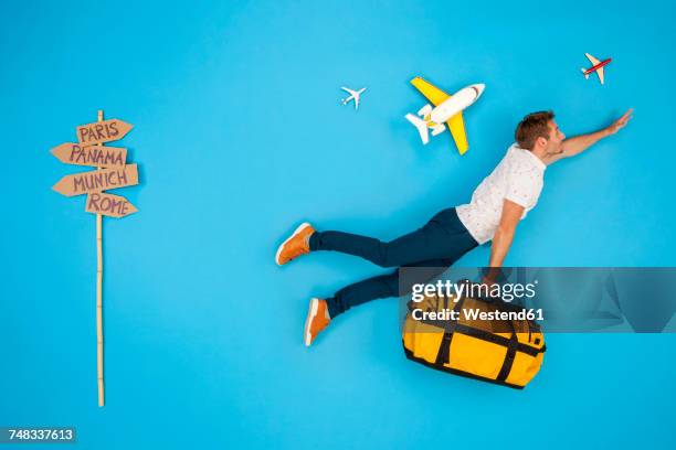 man with suitcase hurrying to to get his flight for a city break - men doing quirky things stock pictures, royalty-free photos & images