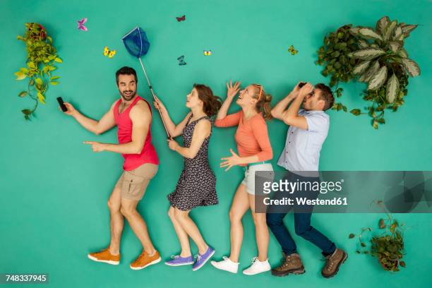 man guiding tour group through the jungle - catching butterflies stock pictures, royalty-free photos & images