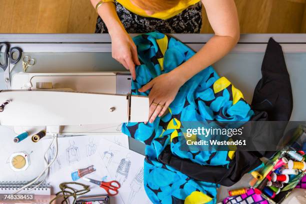 fashion designer working with sewing machine, top view - italian designers stock-fotos und bilder