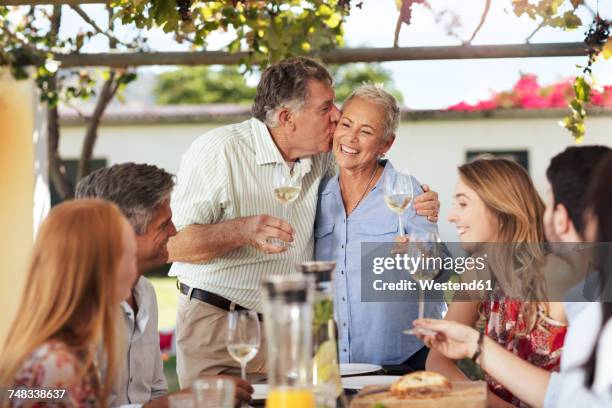 happy senior couple with family having lunch together outside - happy anniversary stock-fotos und bilder