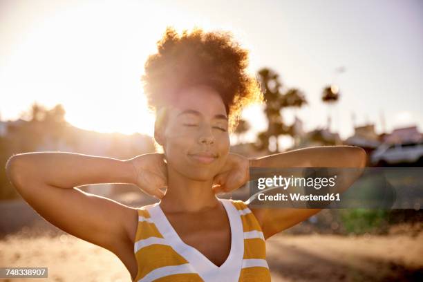 portrait of woman with eyes closed relaxing on the beach - relaxed sunshine happy lens flare stock pictures, royalty-free photos & images