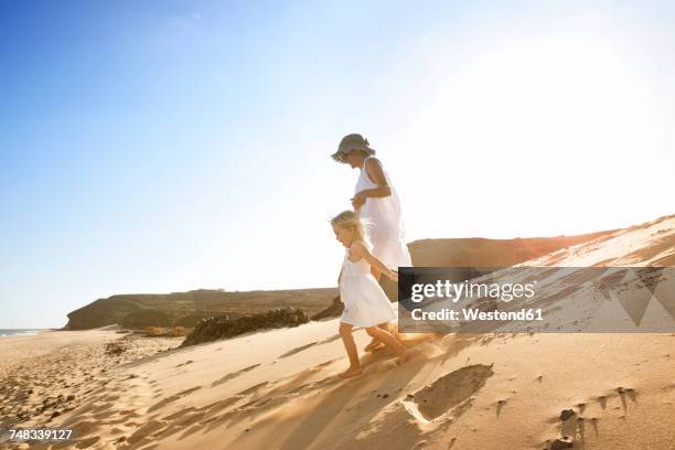 spain, fuerteventura, mother running with daughter on the beach - canary fotografías e imágenes de stock
