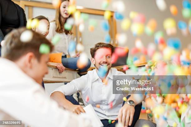 playful creative professionals meeting in office - fun at work stockfoto's en -beelden