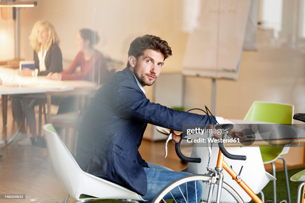 Businessman with bicycle in office