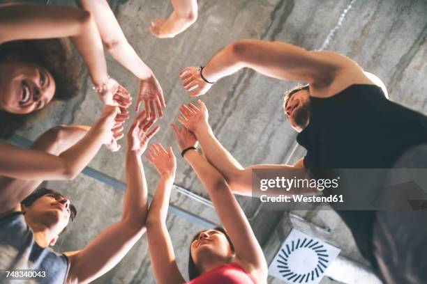 group of young people huddling in gym - asian ceiling stock-fotos und bilder