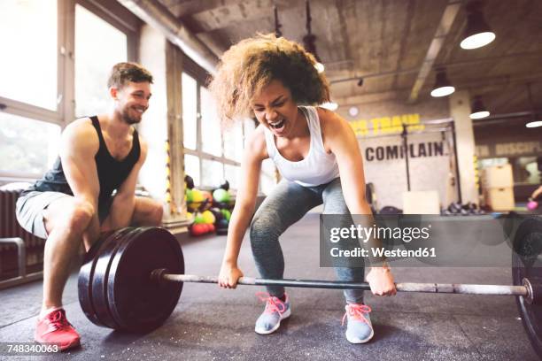 young woman with training partner preparing to lift barbell in gym - weight training 個照片及圖片檔