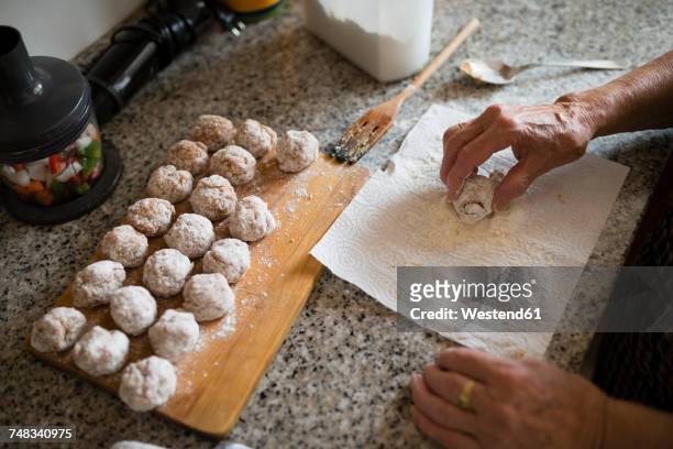 hand of senior woman preparing meatballs in the kitchen, close-up - meatball fotografías e imágenes de stock