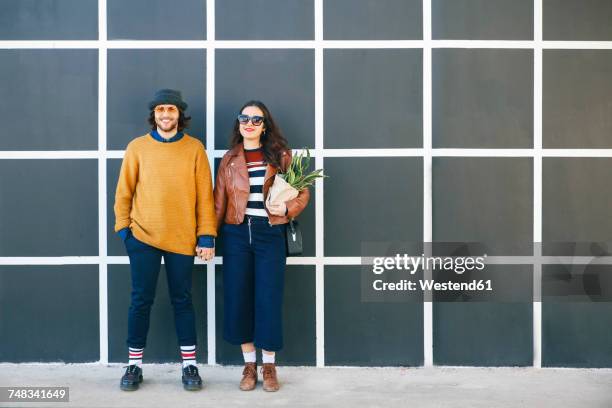 young couple hand in hand - hipster couple bildbanksfoton och bilder