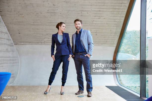 portrait of man and woman standing in attic office - business mature couple portrait bildbanksfoton och bilder