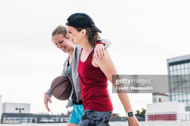 two happy women with basketball in the city - womens basketball stock-fotos und bilder