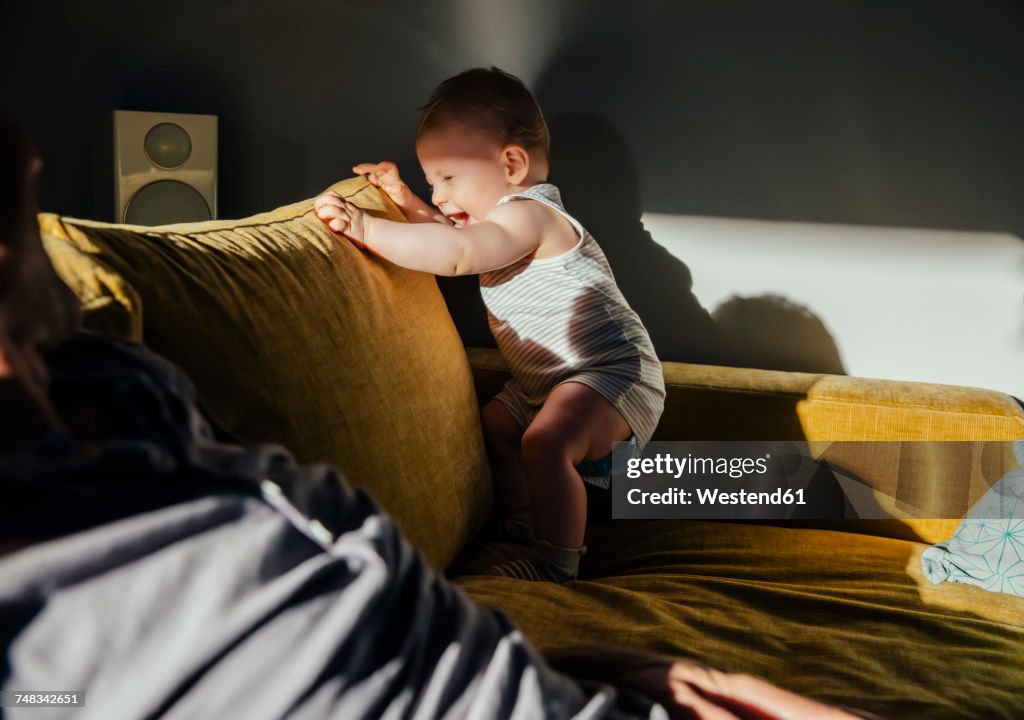 Baby boy rocking on couch