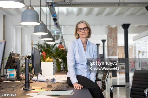 mature business woman working in office - unhappy woman blonde glasses stock pictures, royalty-free photos & images