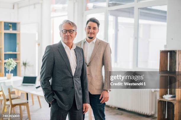 portrait of confident old and young businessman in office - father son business europe stock pictures, royalty-free photos & images