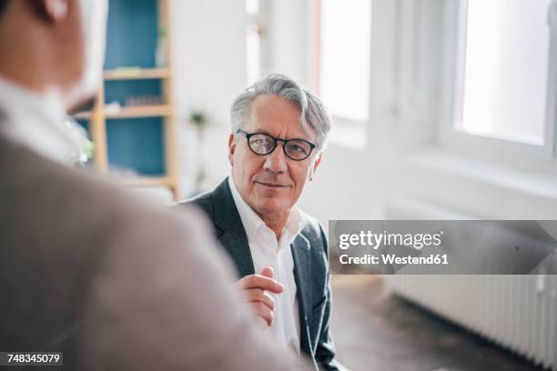 senior businessman with partner in office - successor stock pictures, royalty-free photos & images