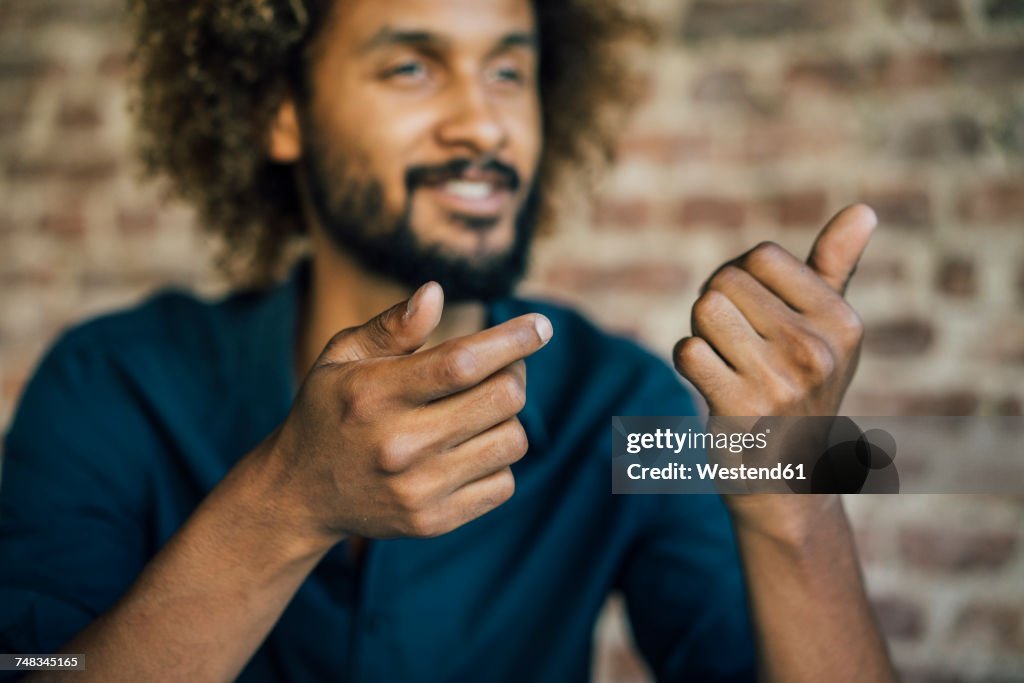 Man with beard and curly hair gesticulating