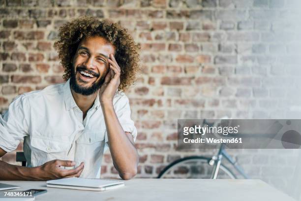 Happy young man at desk