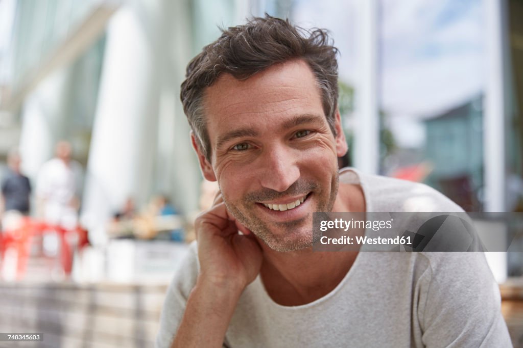 Portrait of smiling man at an outdoor cafe