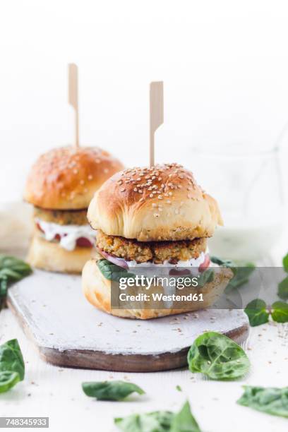 vegetarian burger with halloumi zucchini carrot patty, tzatziki sauce, homemade bun - veggie burger stock pictures, royalty-free photos & images