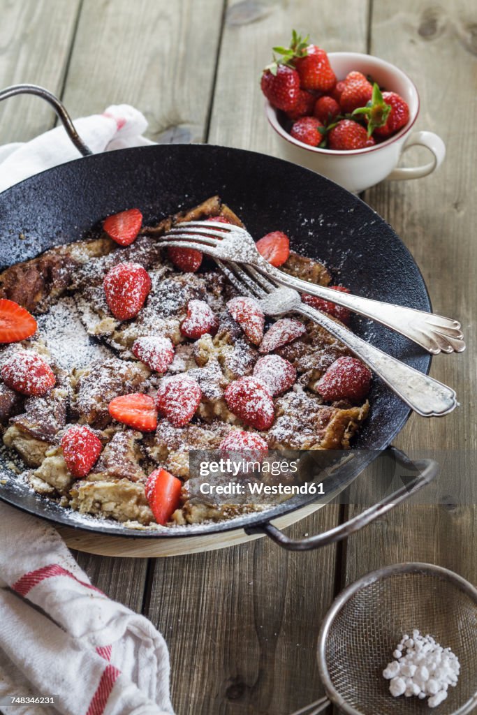 Kaiserschmarrn with fresh strawberries and icing sugar