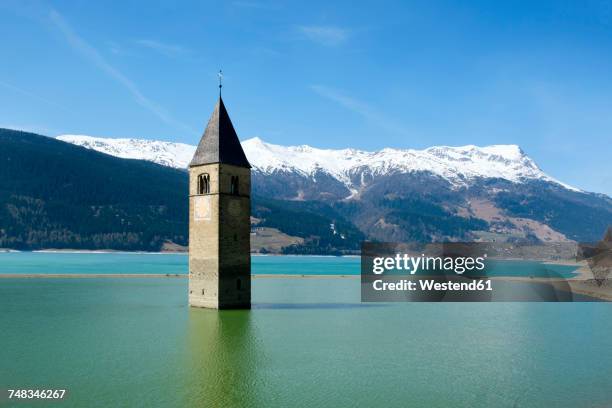 italy, alto adige, church spire of alt-graun in lake reschen - 貯水池 ストックフォトと画像