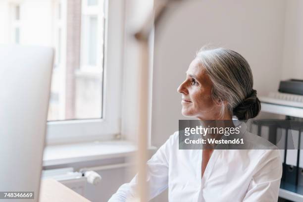 confident businesswoman in office thinking - white blouse stock pictures, royalty-free photos & images