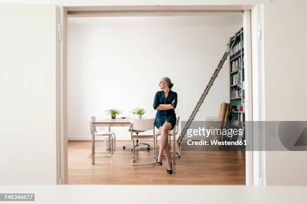 businesswoman sitting in modern office - step stool stock pictures, royalty-free photos & images
