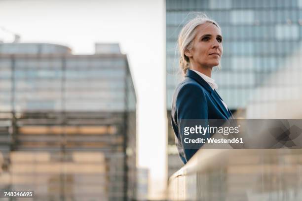 businesswoman standing on bridge - selective focus stock-fotos und bilder