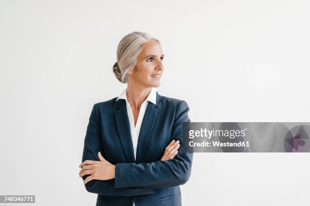 smiling businesswoman looking sideways - looking away stock-fotos und bilder