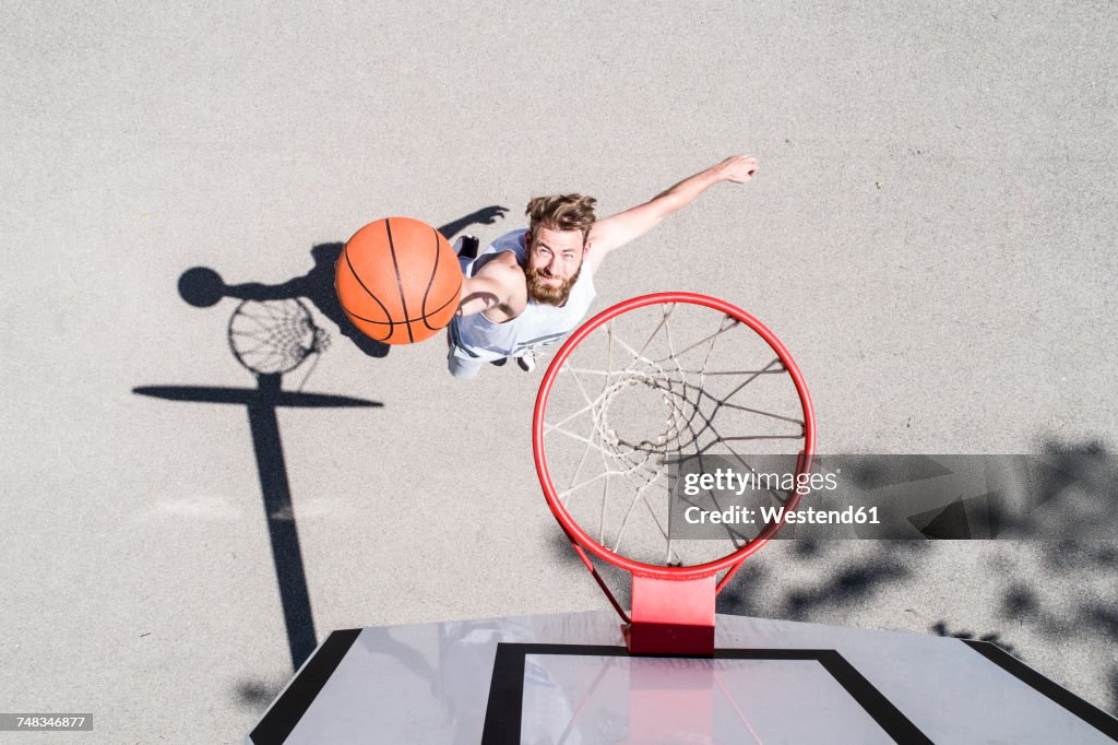 Man playing basketball on outdoor court