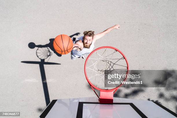 man playing basketball on outdoor court - scoring a goal ストックフォトと画像