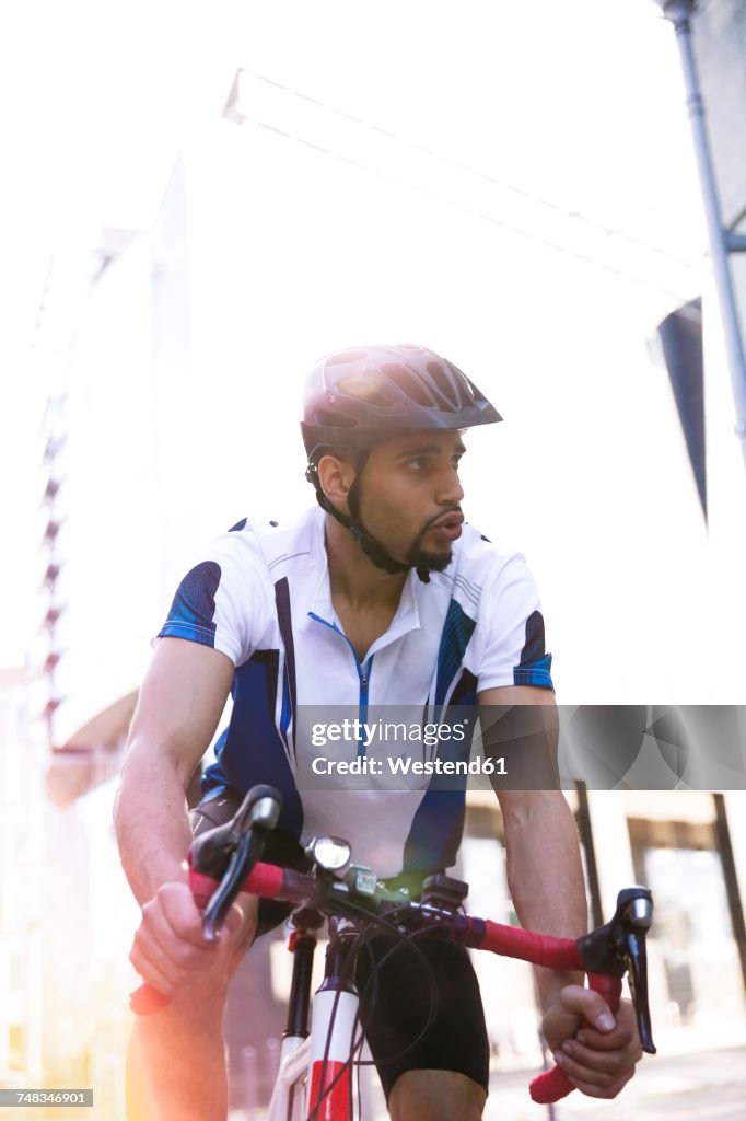 Young man riding bicycle in the city