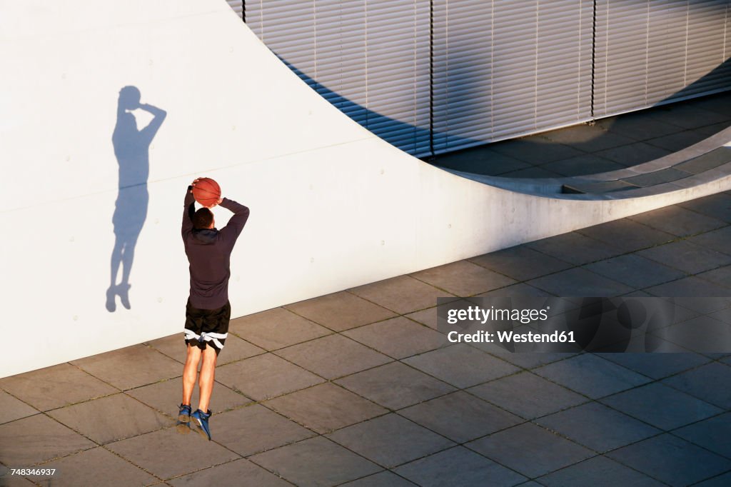 Young man playing basketball in the city