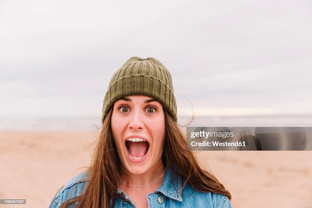 Portrait of woman pulling funny face on the beach