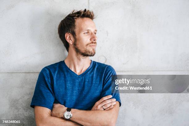 portrait of a man standing in front of wall - human age stock-fotos und bilder