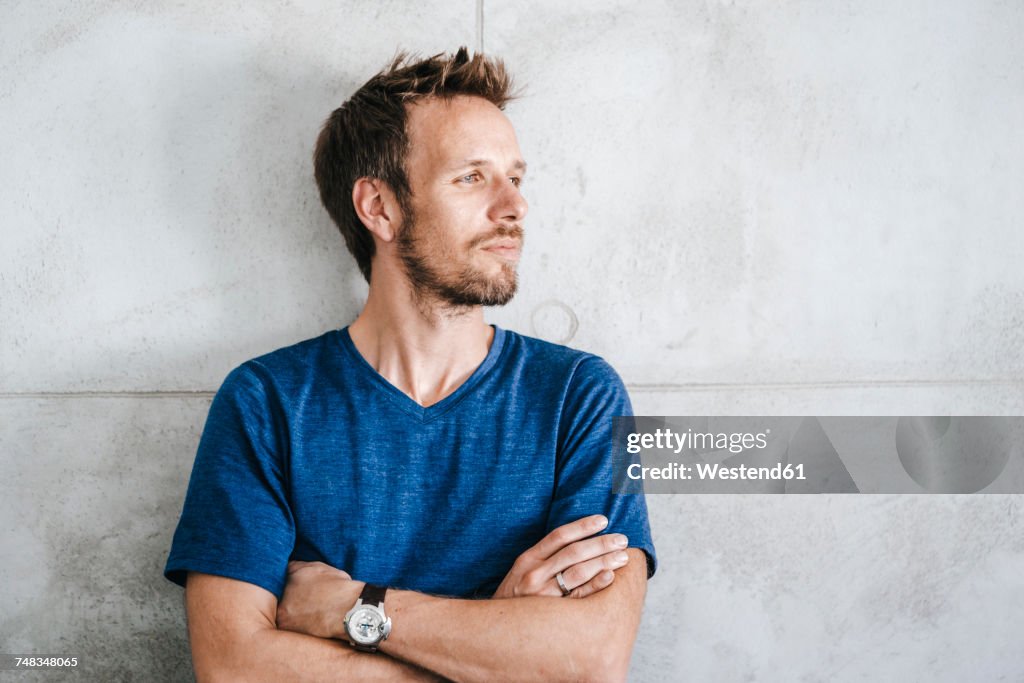 Portrait of a man standing in front of wall