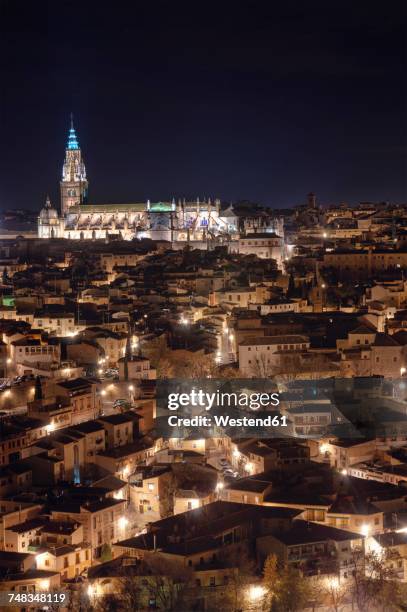 spain, toledo, view to lighted cathedral and cityscape at night - toledo cathedral stock pictures, royalty-free photos & images