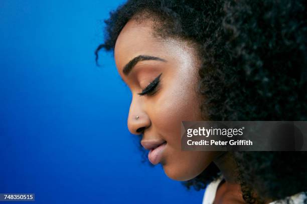 profile of pensive black woman - 鼻ピアス ストックフォトと画像
