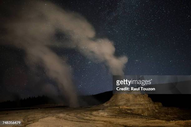 castle geyser with milky way in lower geyser basin. - great fountain geyser stock pictures, royalty-free photos & images