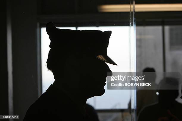 San Francisco, UNITED STATES: Tourists walk past a dummy of a prison guard as they visit Alcatraz Island, 14 June 2007 in San Francisco Bay of...