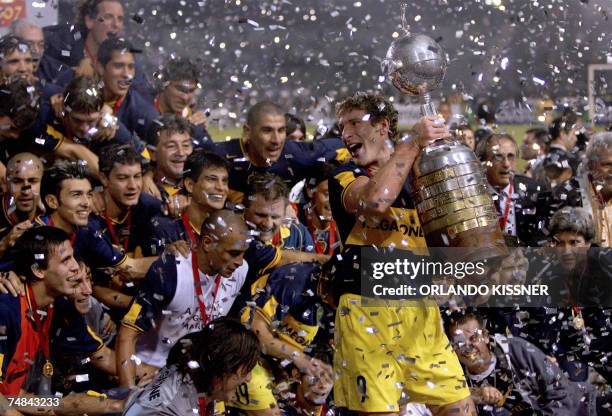 Boca Juniors team captain Martin Palermo holds the Libertadores Cup trophy won after defeating Gremio by 2-0, 20 June 2007 in their final match...