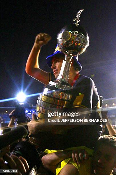 Juan Roman Riquelme of Boca Juniors holds the Libertadores Cup trophy after defeating Brazil's Gremio , 20 June 2007, during the final match at...