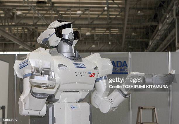 The HRP-3 Promet Mk-II water-proof humanoid robot moves into a shower room during its press preview at Kawada Industry's laboratory in Haga town,...