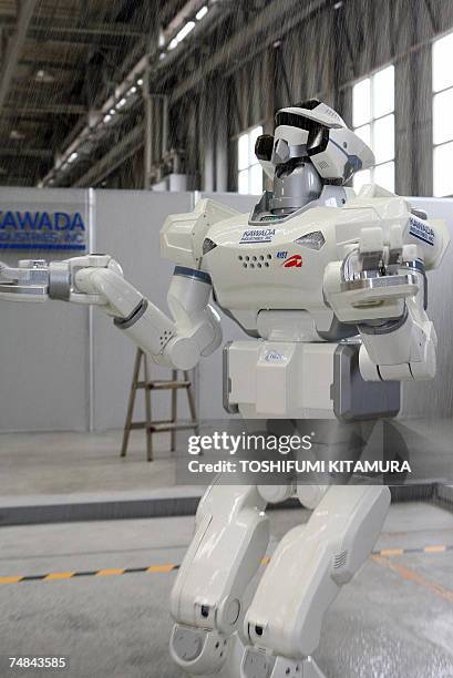 The HRP-3 Promet Mk-II water-proof humanoid robot moves into a shower room during its press preview at Kawada Industry's laboratory in Haga town near...