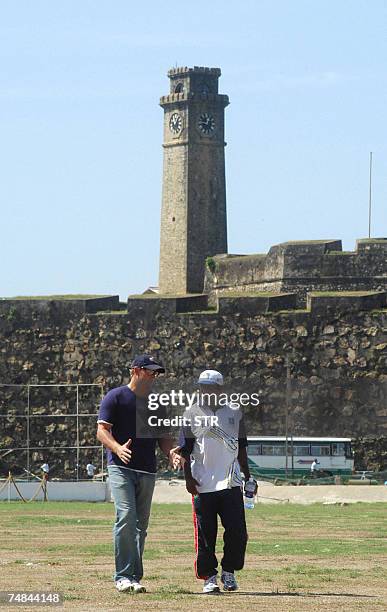 In this picture taken 09 February 2005, Australian cricketer Shane Warne gestures as he speaks with Sri Lankan cricketer Muttiah Muralitharan while...
