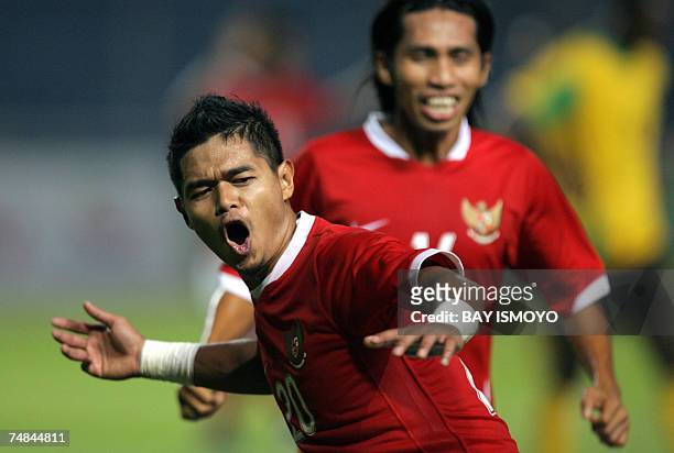 Indonesian footballer Bambang Pamungkas celebrates with teammate Syamsul Bahri after scoring against Jamaica during a friendly match in Jakarta, 21...