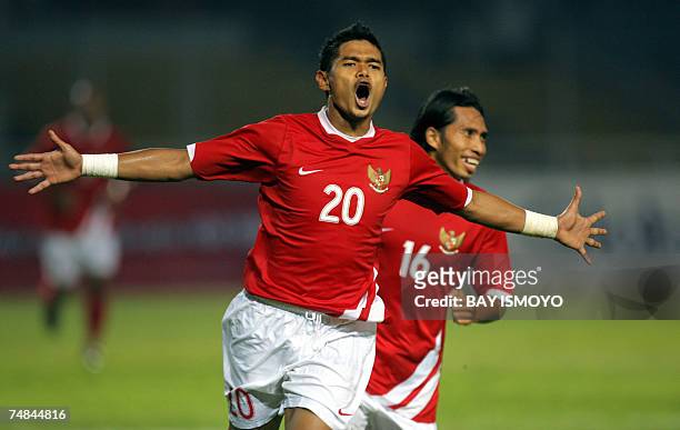 Indonesian footballer Bambang Pamungkas celebrates with teammate Syamsul Bahri after scoring against Jamaica during a friendly match in Jakarta, 21...