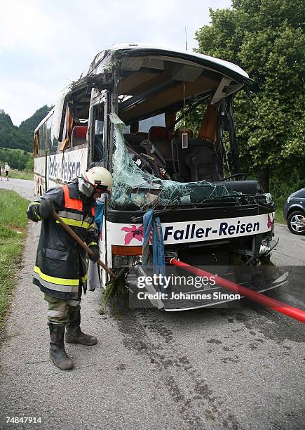 Member of the Austrian firebrigade is cleaning a German tourist bus beside the street after a bus crash on June 21, 2007 near Reutte, Austria. One...