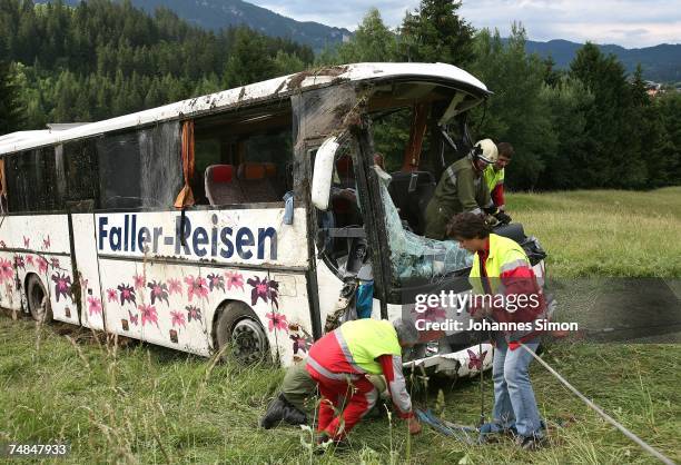 Members of the Austrian firebrigade steer a crashed German Tourist bus out of a pasture on June 21, 2007 near Reutte, Austria. One person was killed...