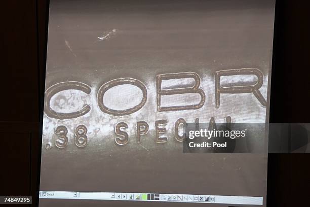 Photograph showing dried blood in the engraving on the barrel of the gun that killed Lana Clarkson is displayed on a screen during the murder trial...